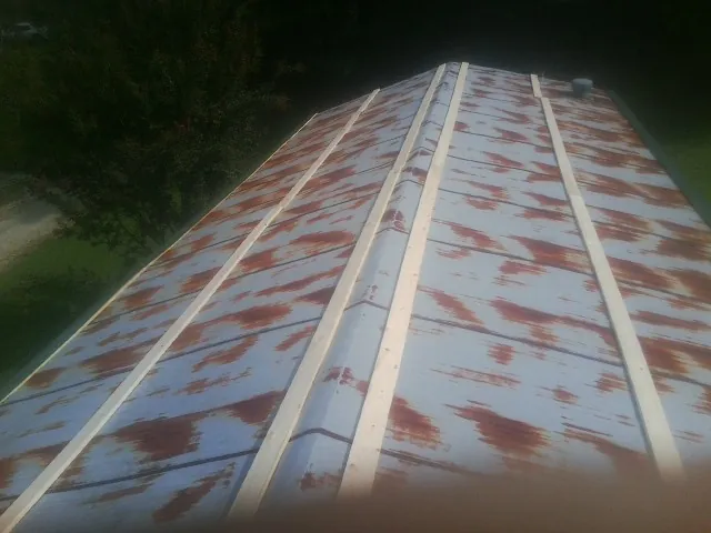 Rusted metal roof panels with new wood purlins before replacement — Storm Damage Roof Repair in Barnhart by Roofing Brothers